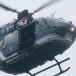 A helicopter with members of the French intervention gendarme forces hover above the scene of a hostage taking at an industrial zone in Dammartin-en-Goele, northeast of Paris